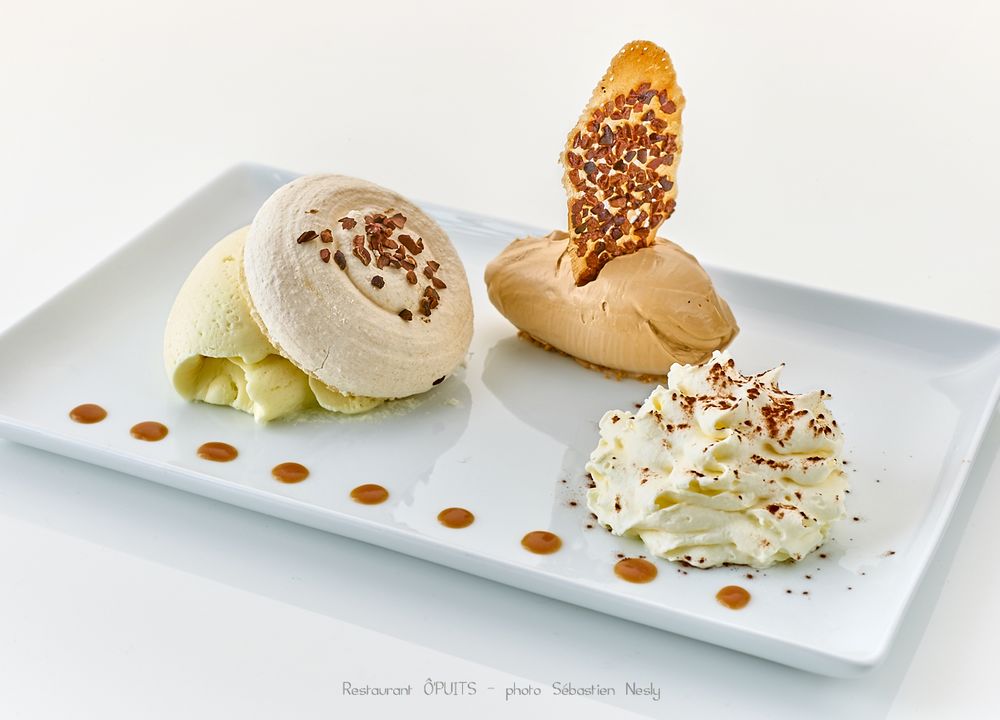 Elegant dessert plate featuring caramel drizzle and sprinkled toppings on white rectangular dish.
