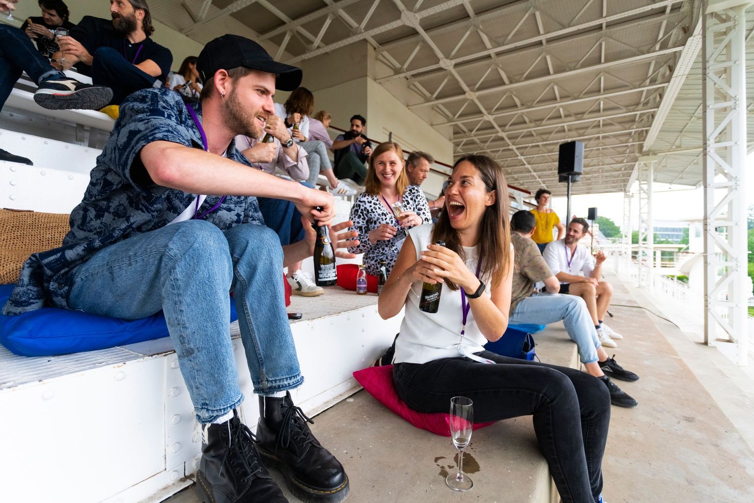 People socializing and relaxing on stadium-style seating steps.