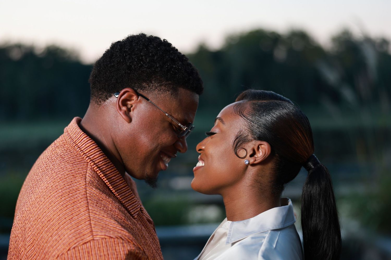 Engagement session at a park with a huge pond.