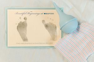 Baptist hospital Beautiful Beginnings newborn footprint keepsake card with blue hat and striped outfit.