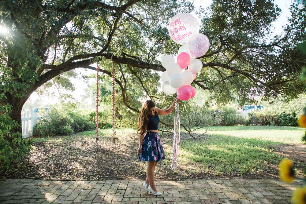 girl holding balloons in front of tree. Memory lane photo spot. Mission, Texas. Wedding photography