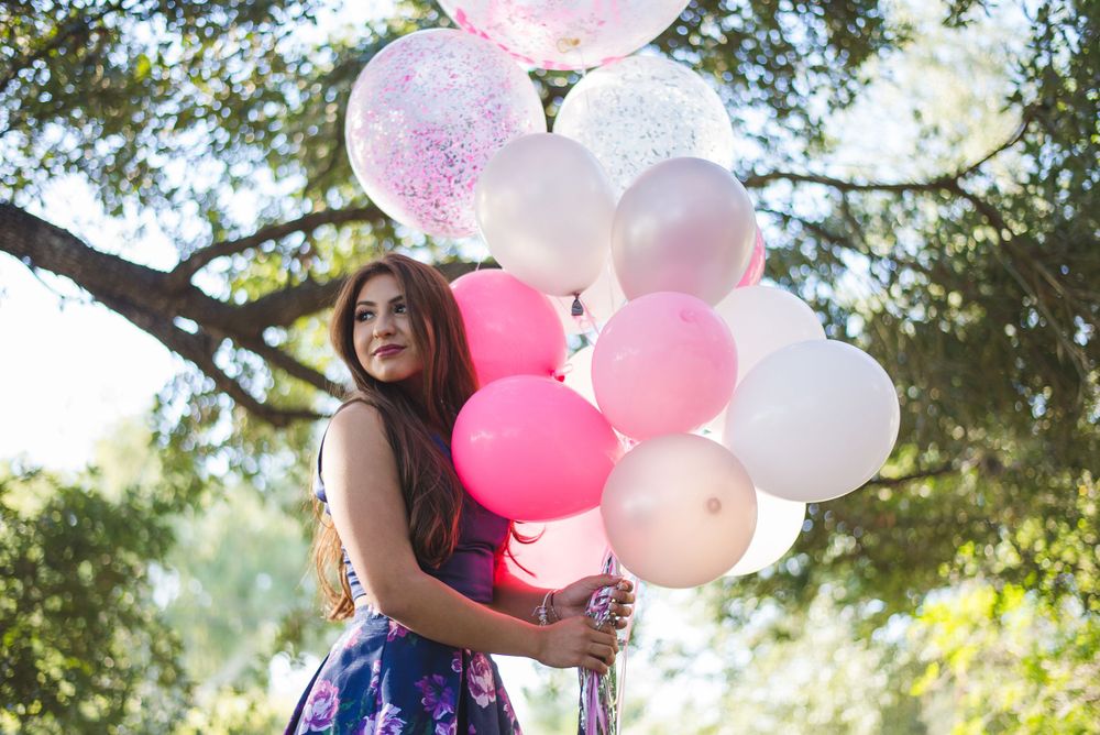 girl holding balloons looking back. Memory lane photo spot. Mission, Texas. Wedding photography