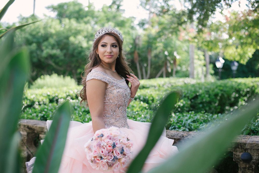 girl behind some green plants. La Quinta Mazatlan. McAllen, Texas. Wedding photography