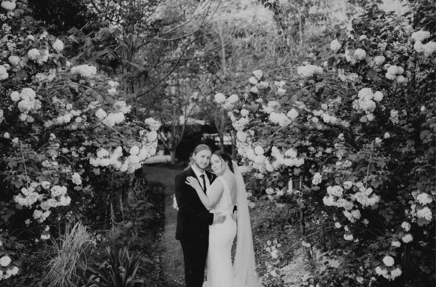 black and white portrait of bride and groom in a garden
