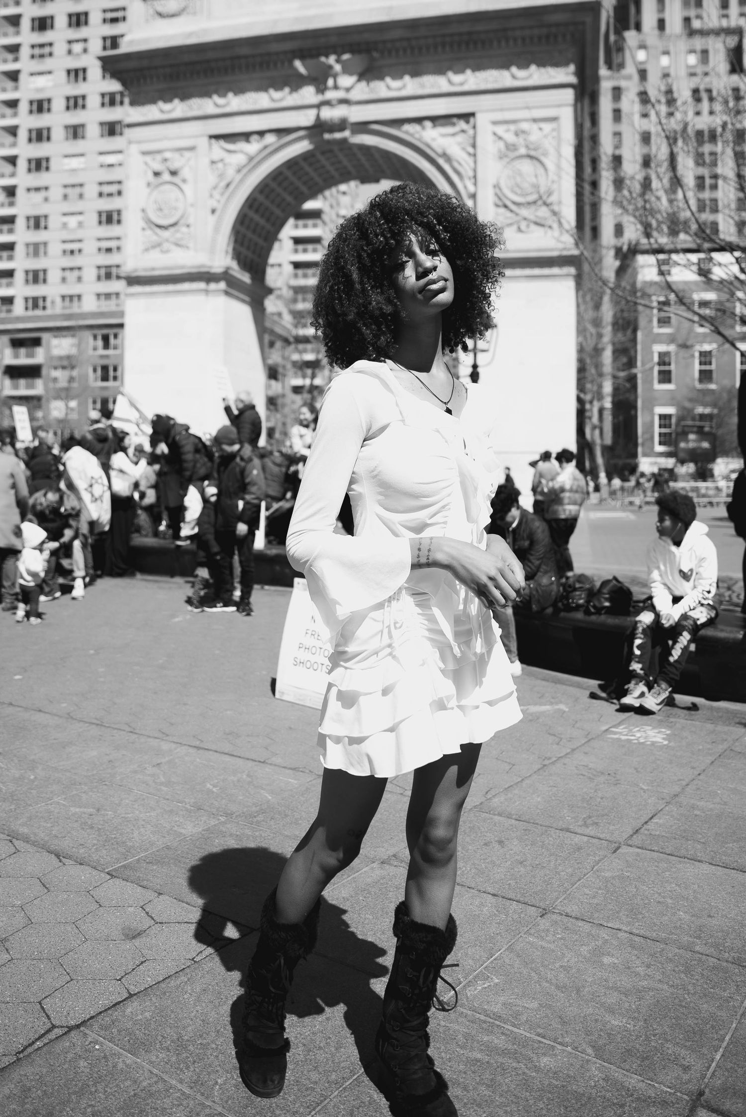 Dynamic black and white dance performance in front of architectural arch.