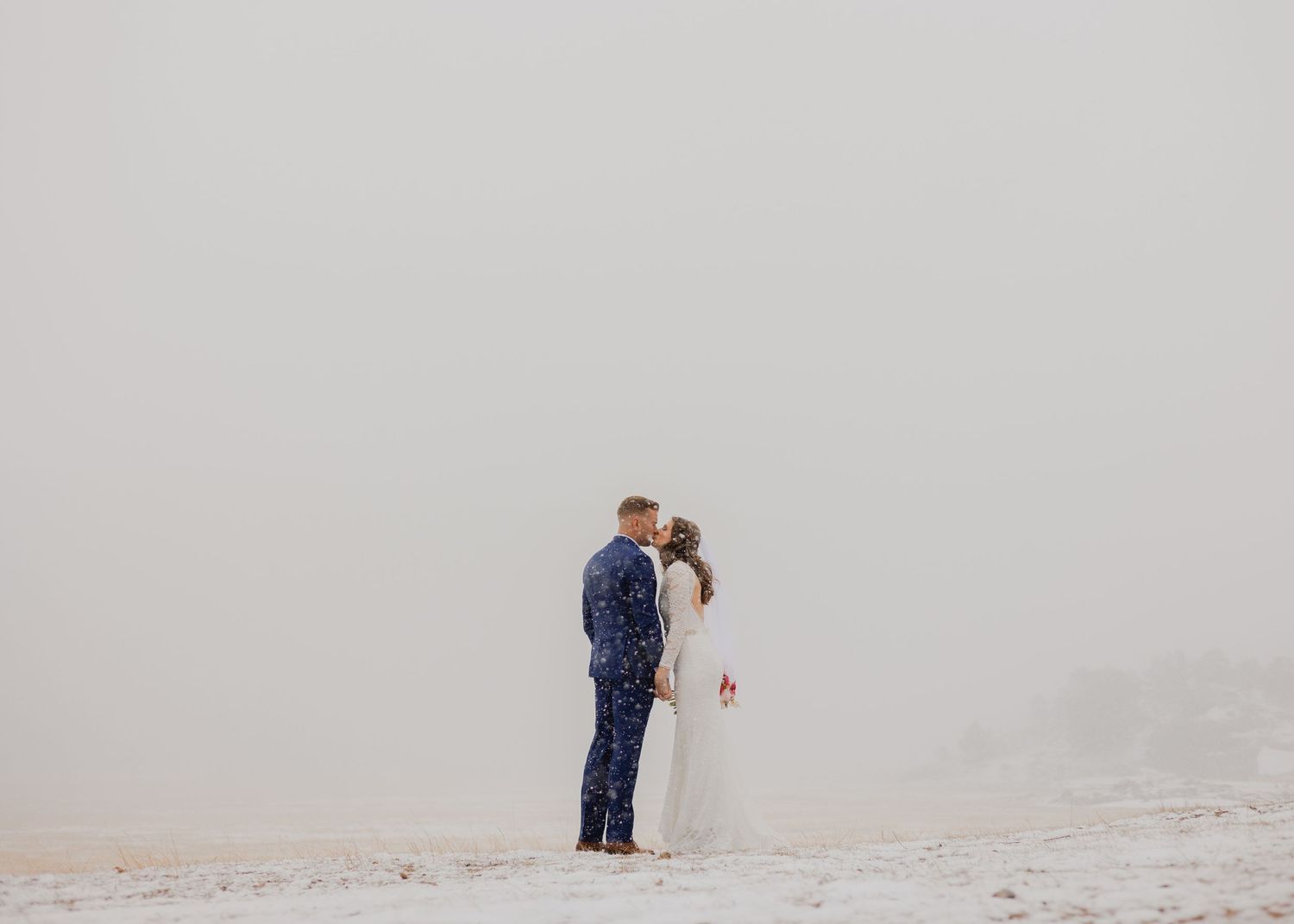 "A Colorado elopement photographer artistically framing a tender moment between the newlyweds, accentuating the beauty o