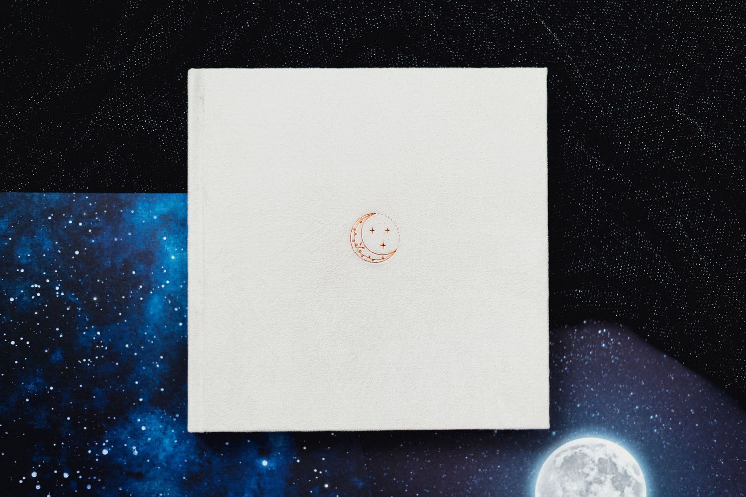 Photo album pages with celestial theme and full moon imagery.