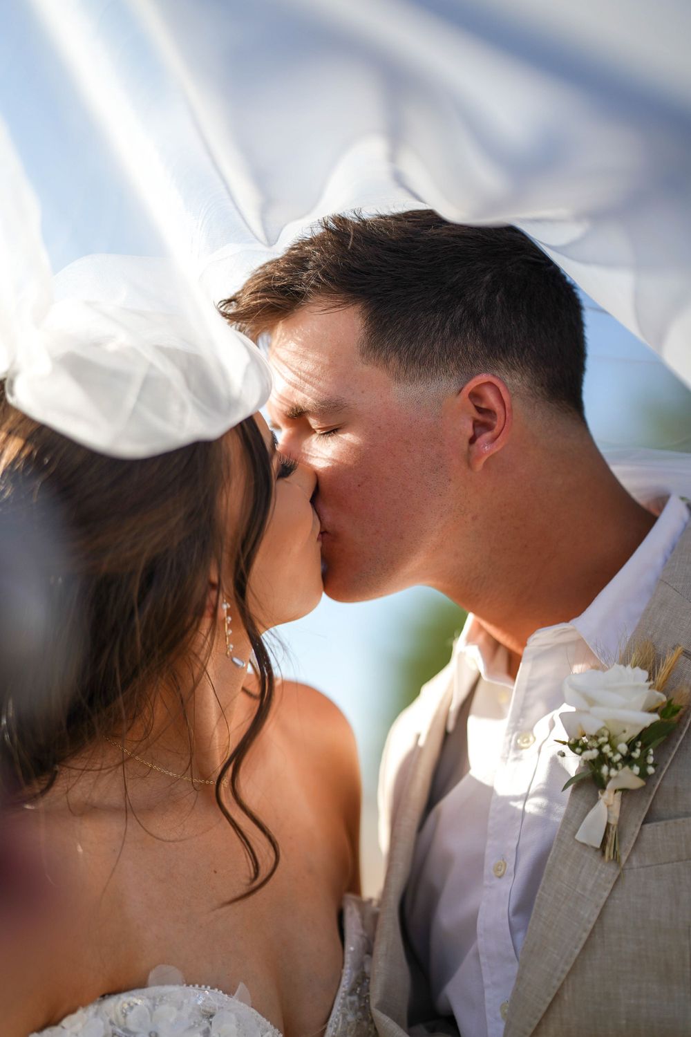 Close-up sequence of a romantic wedding kiss against a soft blurred background.