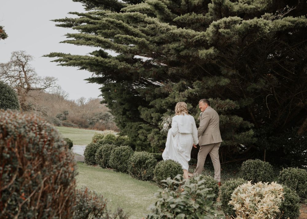 Bride and Groom walking in gardens at St Elizabeth's House Plympton