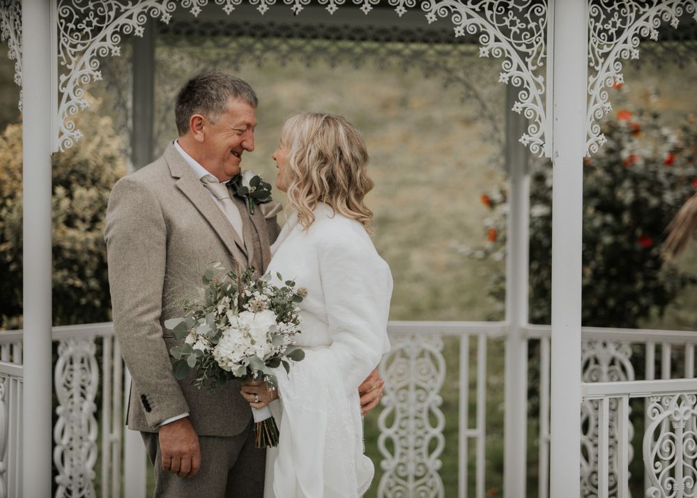 Bride and Groom stood in gardens at St Elizabeth's House in Plympton