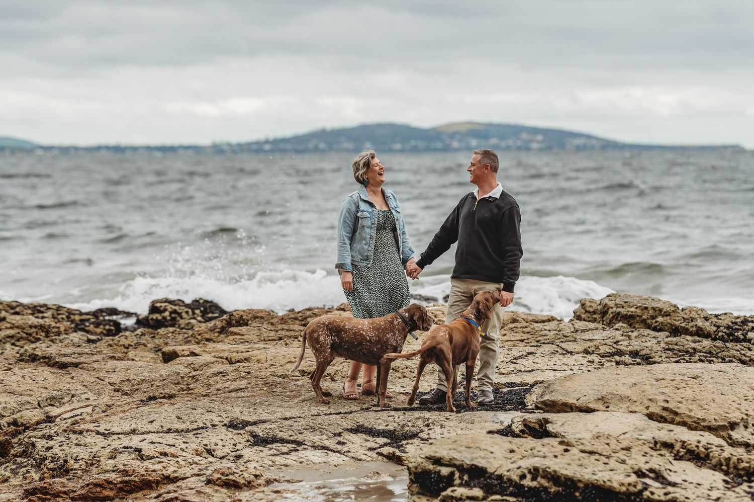 mother and father at tassie beach with dogs during family session by tasmanian photographer joss jensen