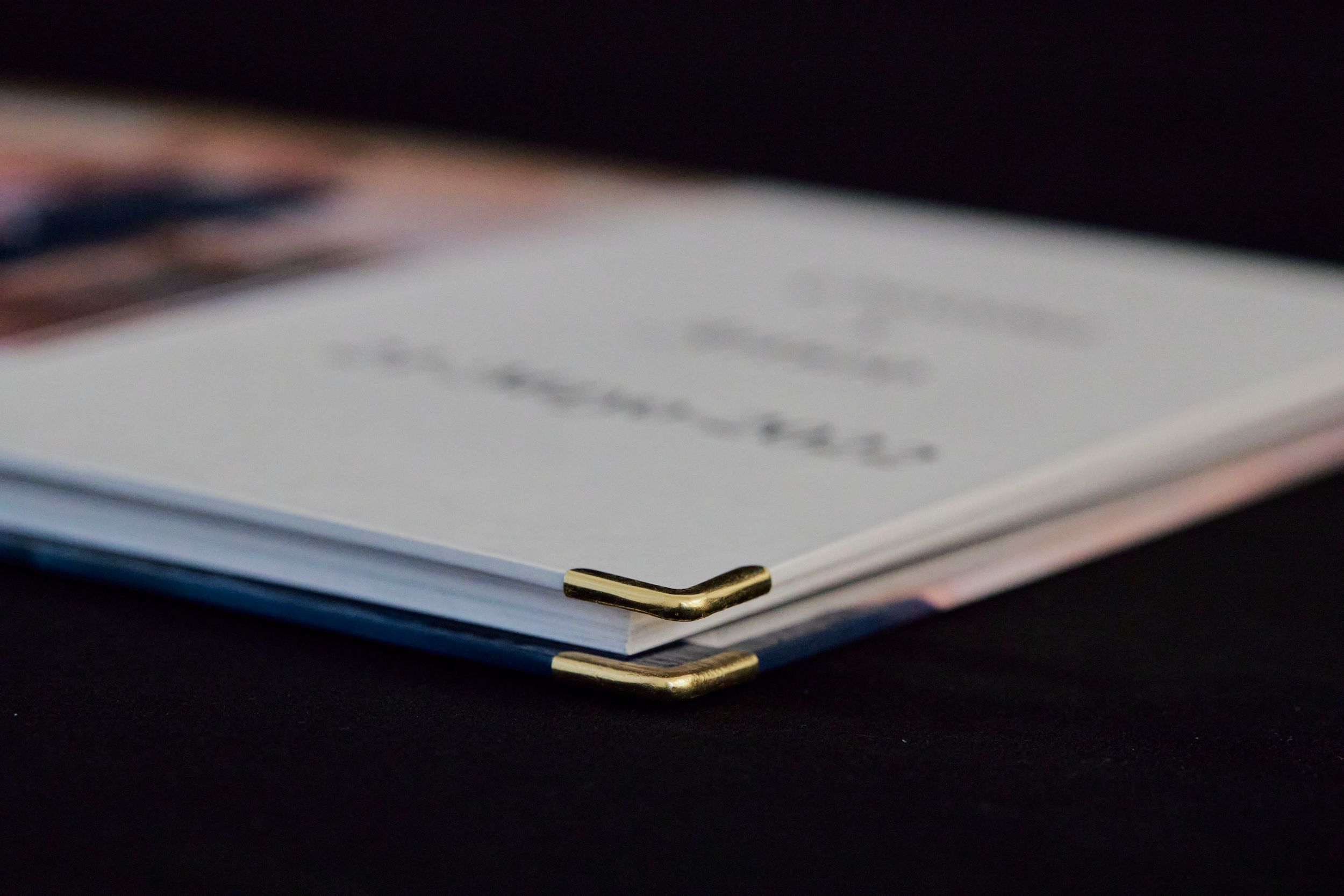 Close-up detail of wedding album spine showing professional binding.