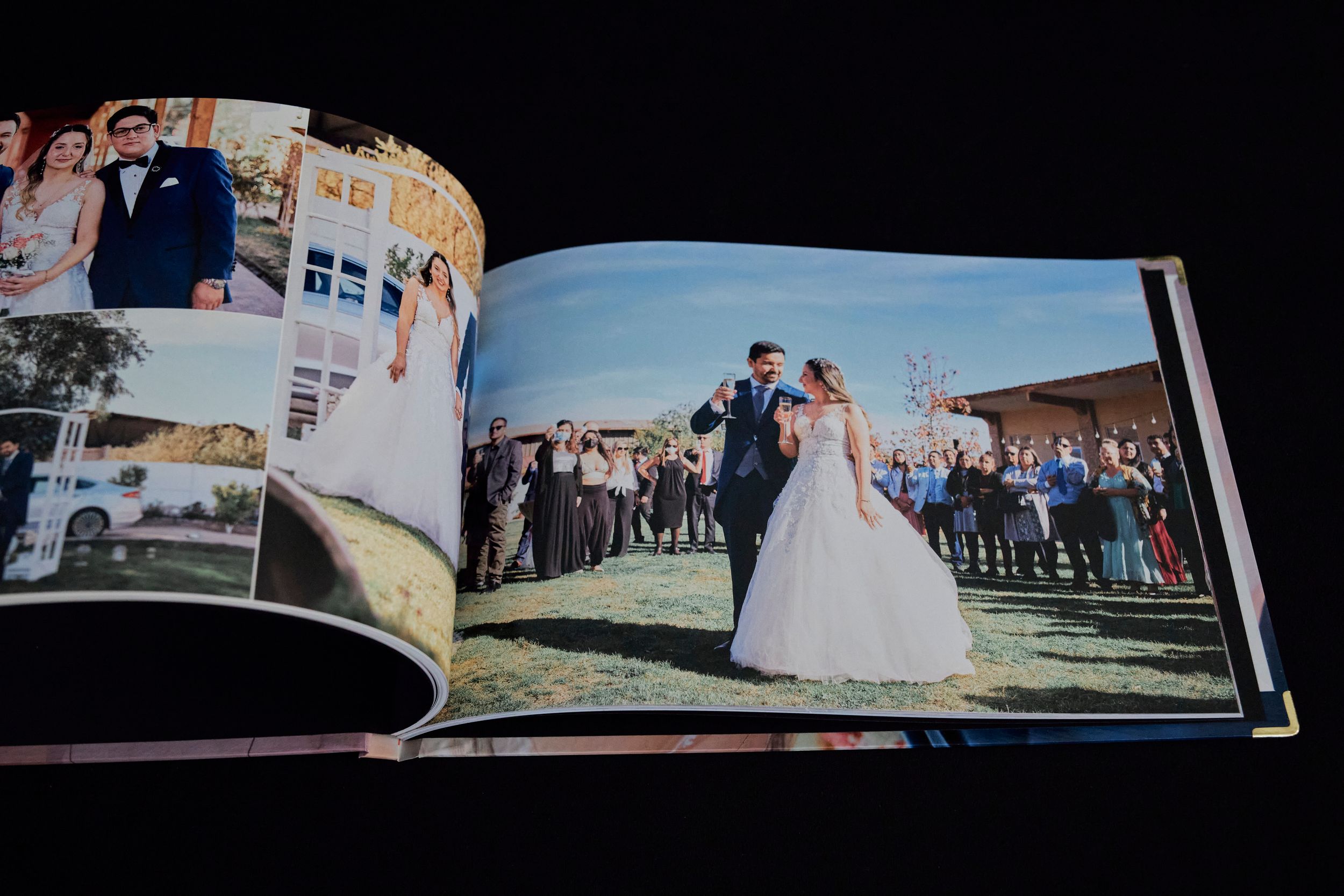 Wedding album spread featuring outdoor reception photos and dancing scenes.