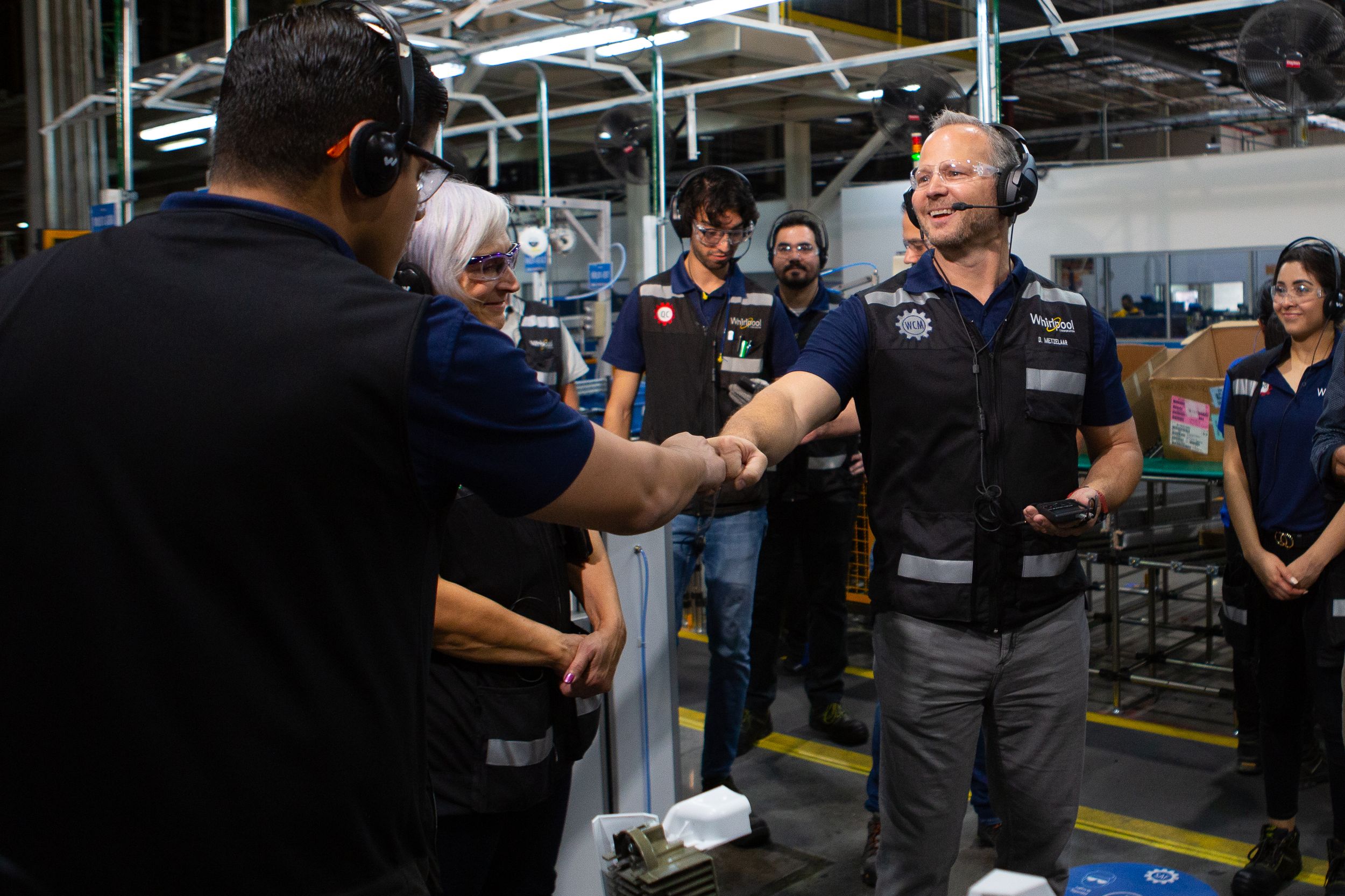 Workers engaging in a team meeting at an industrial facility.