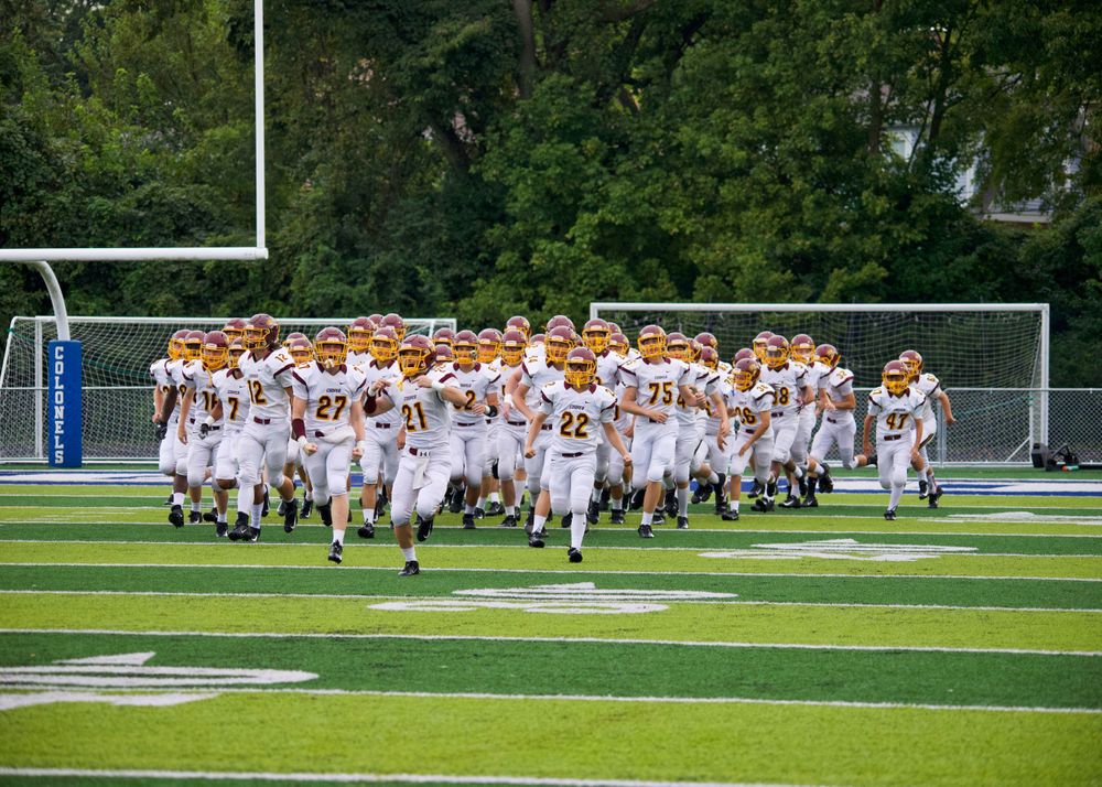 Football team running on to the field