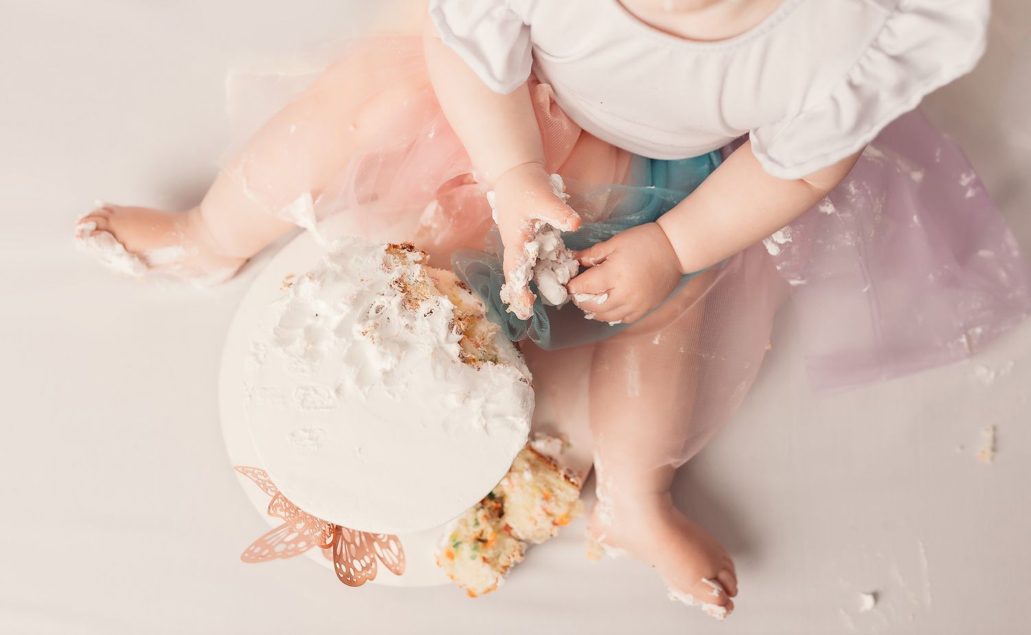 Tulsa cake smash photographer baby girl eating cake