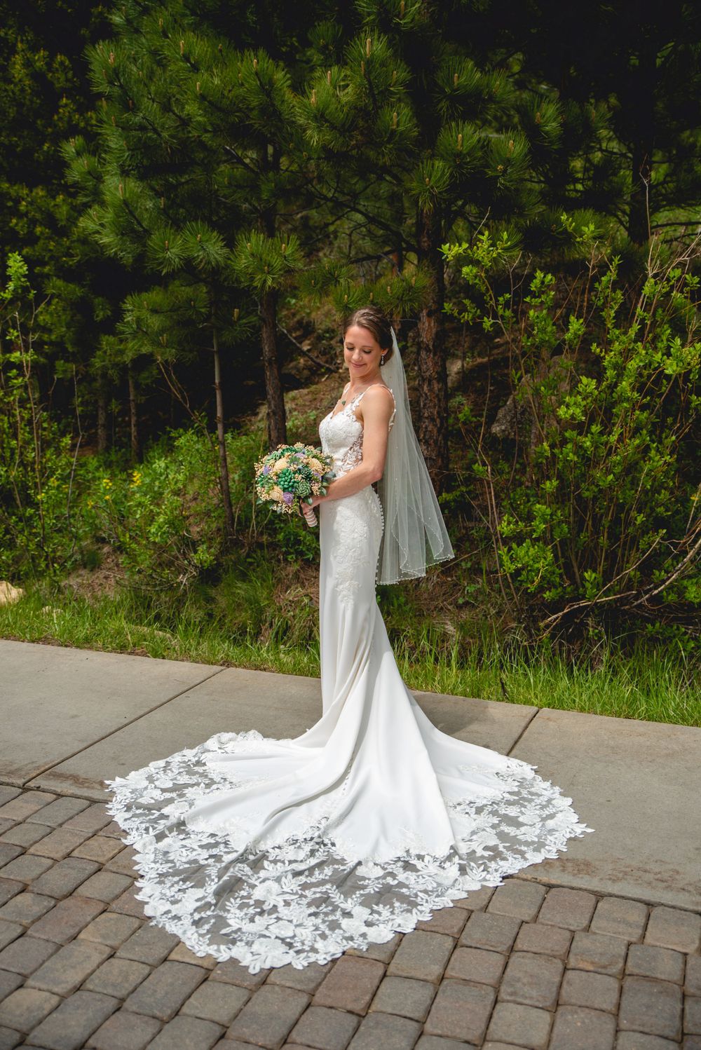 Bride with train laid out, posing for photos