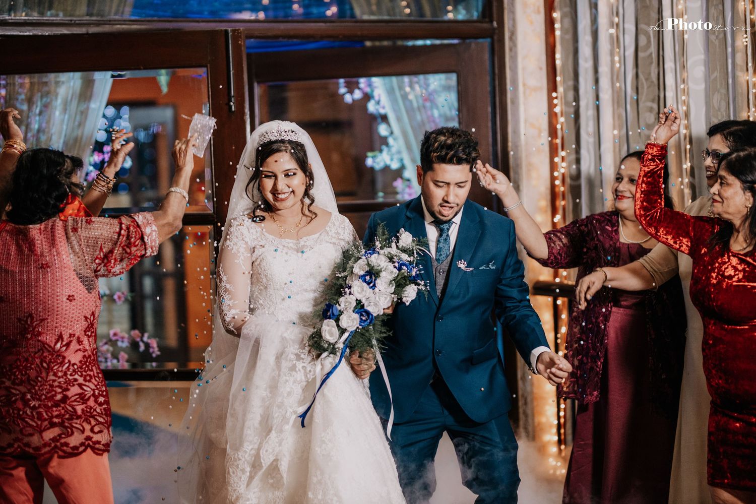 Wedding celebration with couple and guests dancing in formal attire.