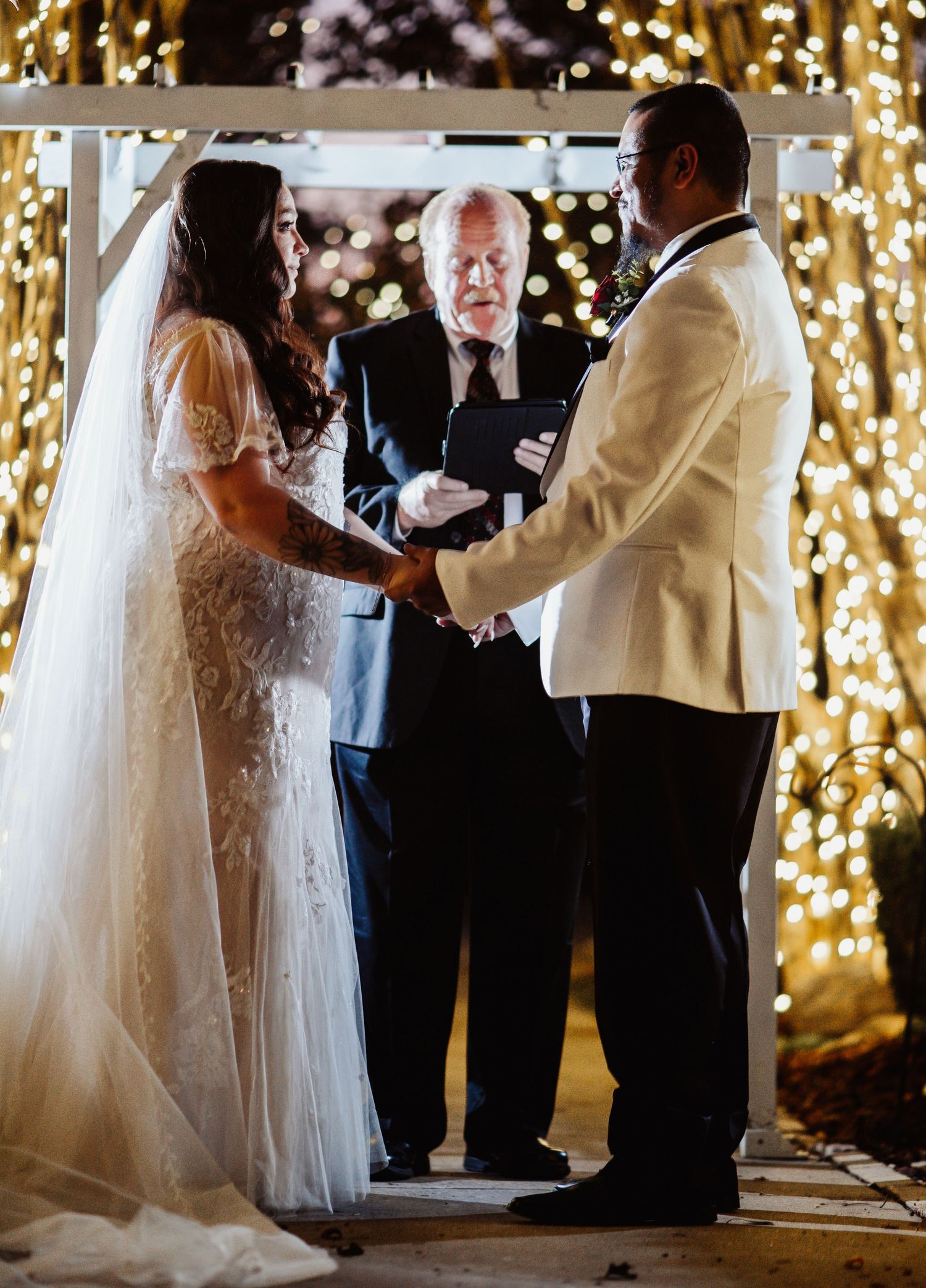 Fort Worth Wedding at the Stock Yards with golden lights and a white ivory dress and white tux