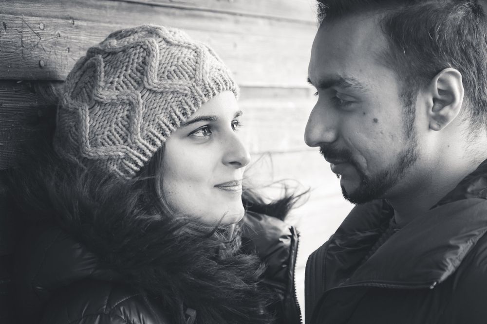A romantic black and white close-up of a couple sharing an intimate moment.