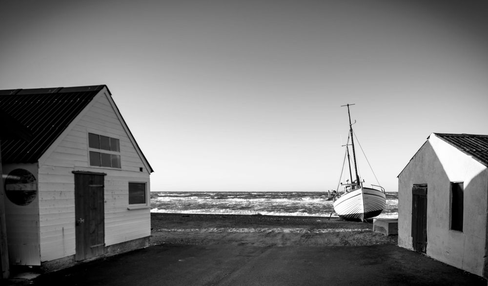 A black and white photo of building from a old fishing society
