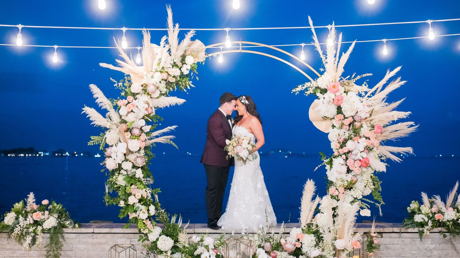 Great moment under the little lights between bride and groom
