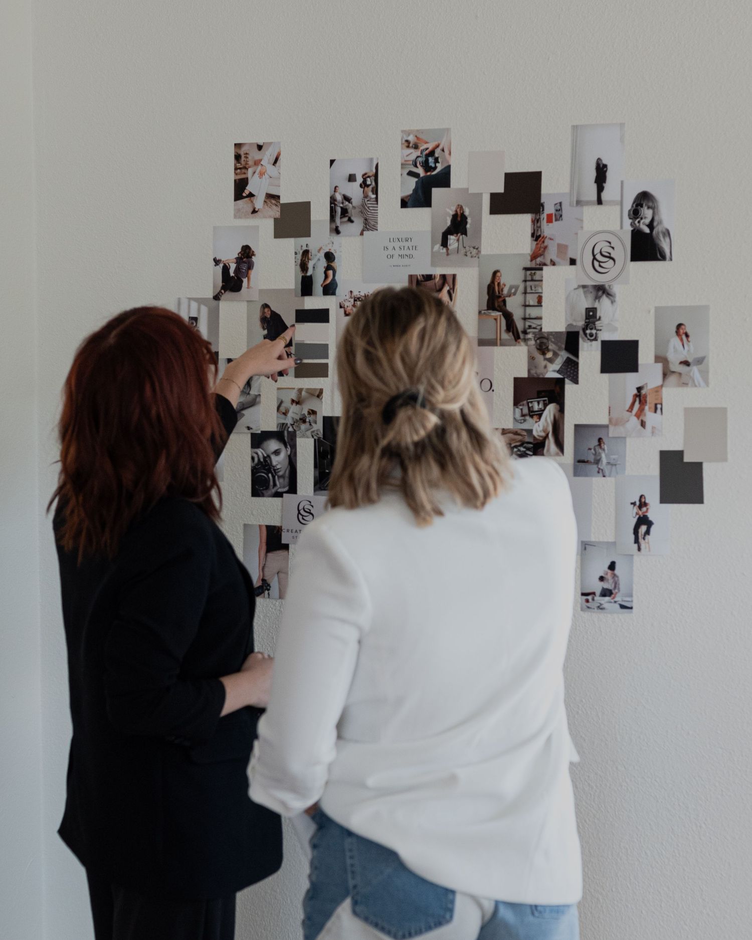 Abie Young pointing to mood board working with a client