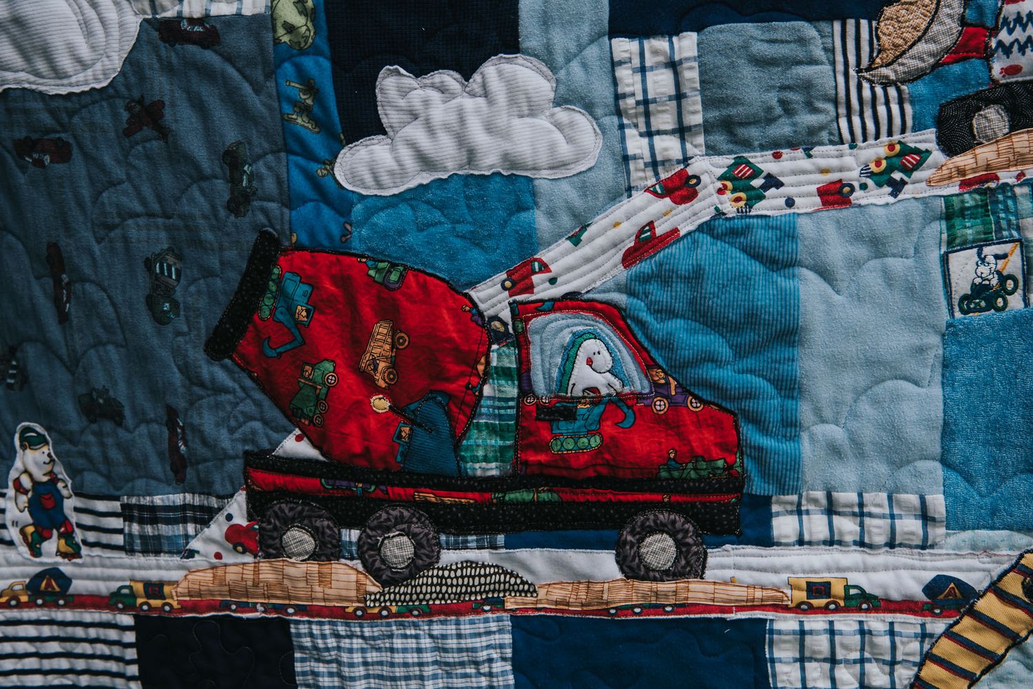 Applique made from clothing for a memory quilt in the shape of a cement truck.
