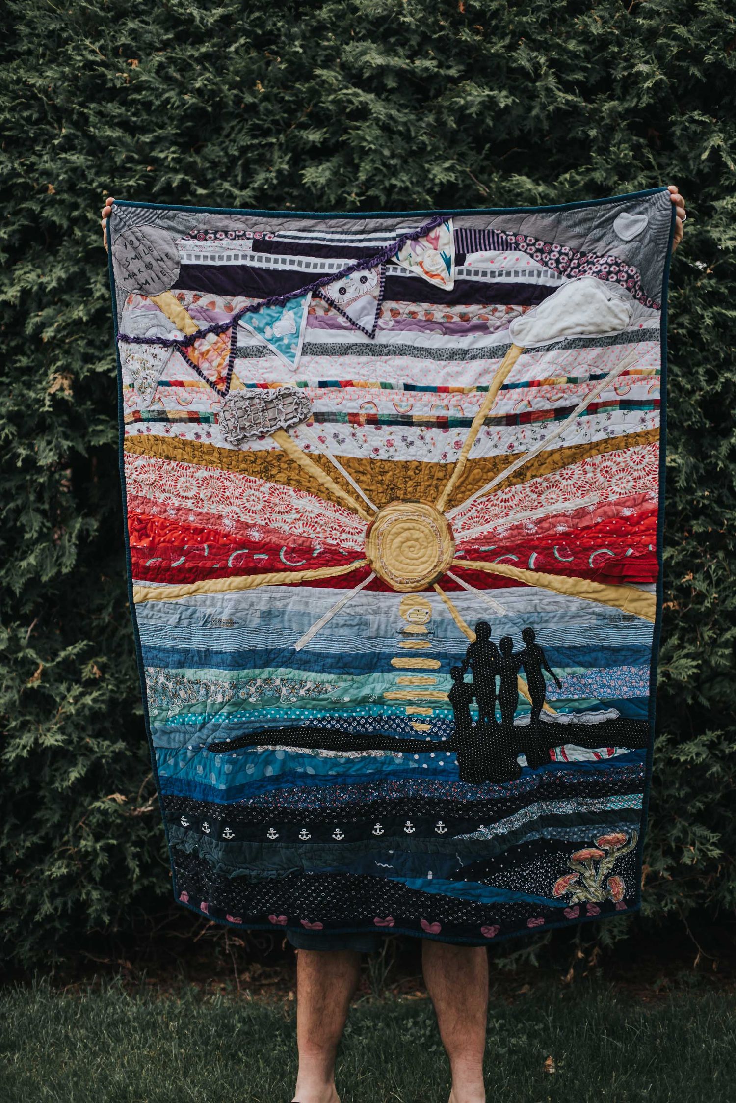 Art Quilt by This Splendid Chaos showing the silhouettes of children standing on a beach at sunset.
