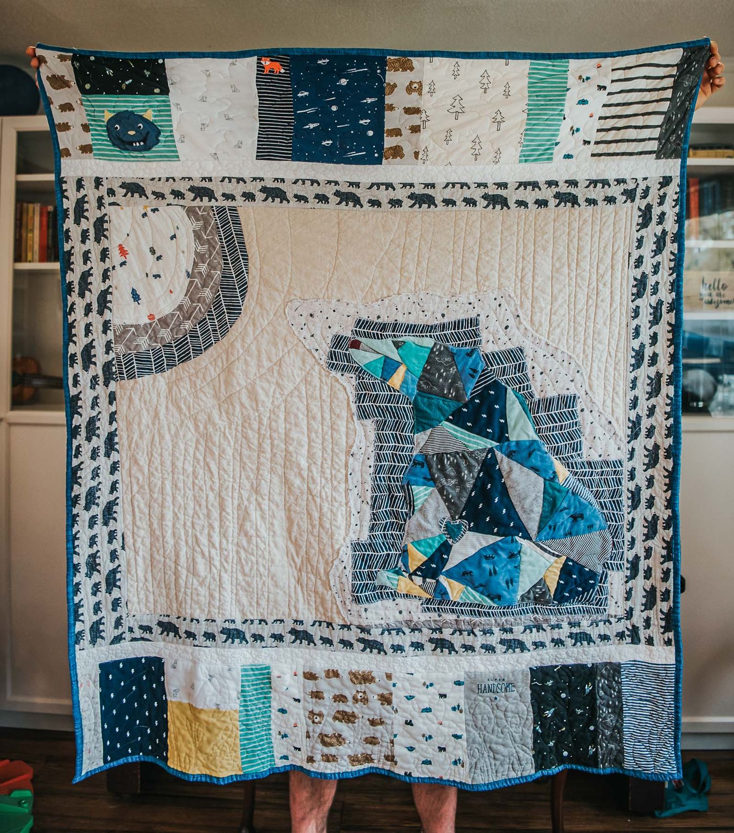Memory quilt by This Splendid Chaos showing a geometric bear in blues made from clothes.