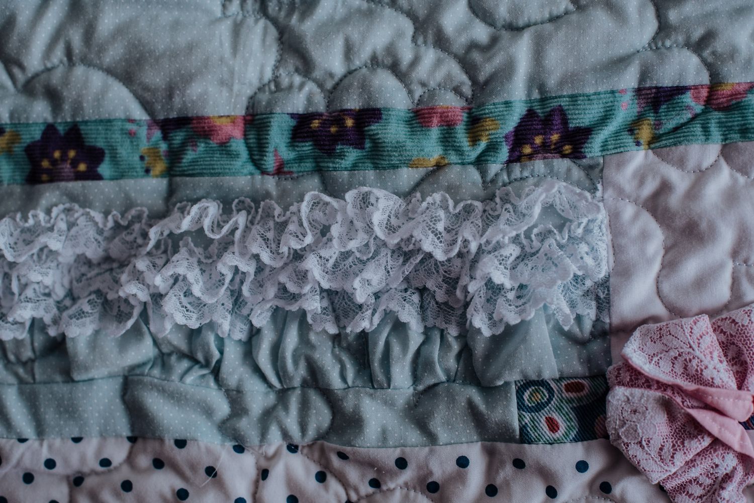 Ruffles from a babies outfit incorporated into a memory quilt.