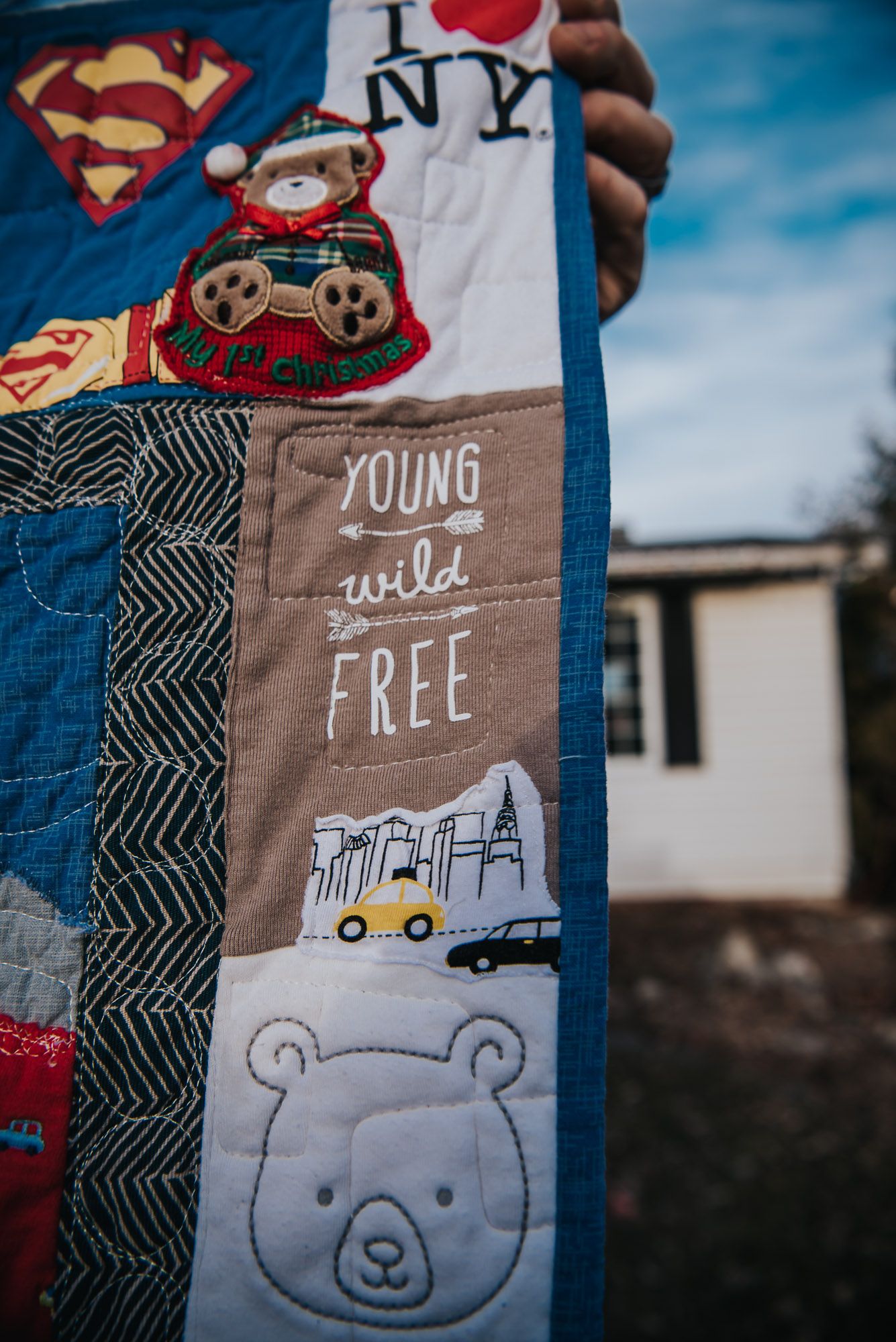memory quilt showing a square that says 'Wild and Free' from a baby onesie.