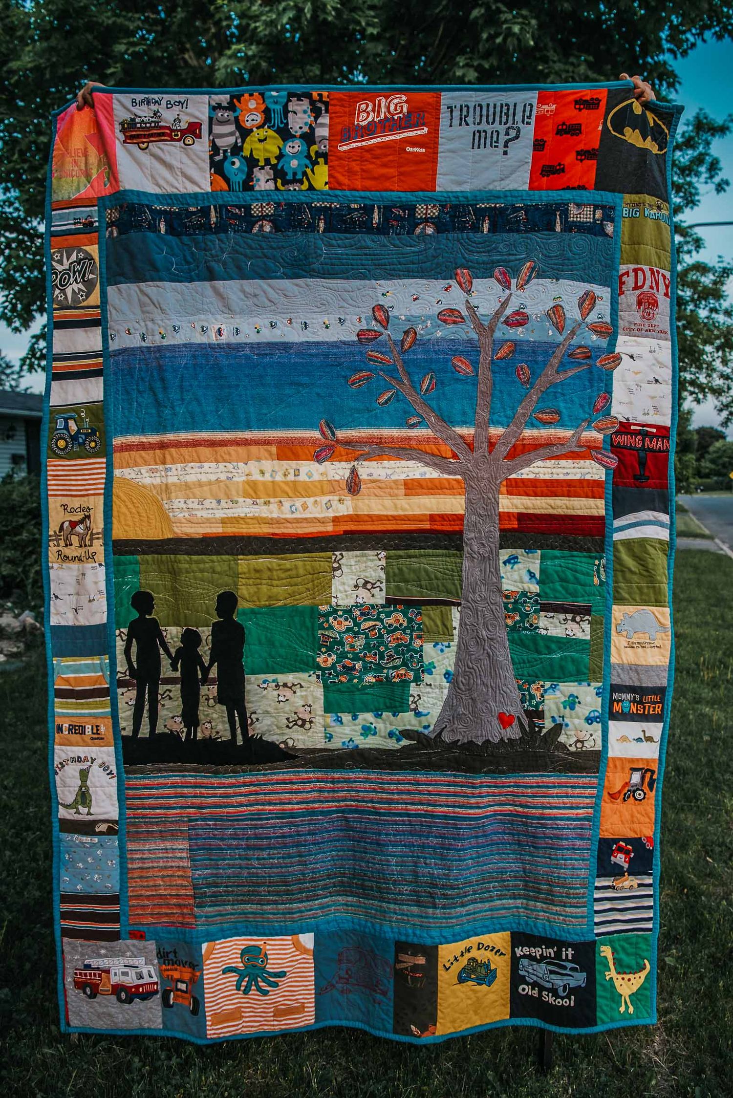 Art memory quilt by This Splendid Chaos called Woven roots, incorporating both baby clothes and woven wraps.