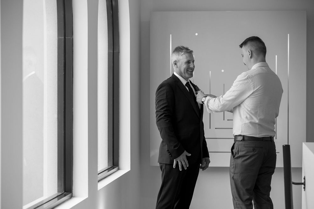 The Groom and his Best Man helping with his suit jacket during wedding preparations at Lancemore Milawa captured