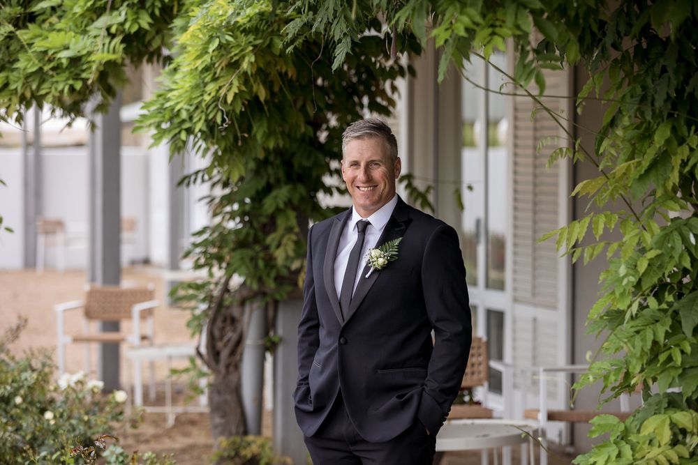 The Groom in his Black wedding suit with button hole flower at Lancemore Milawa before the wedding ceremony