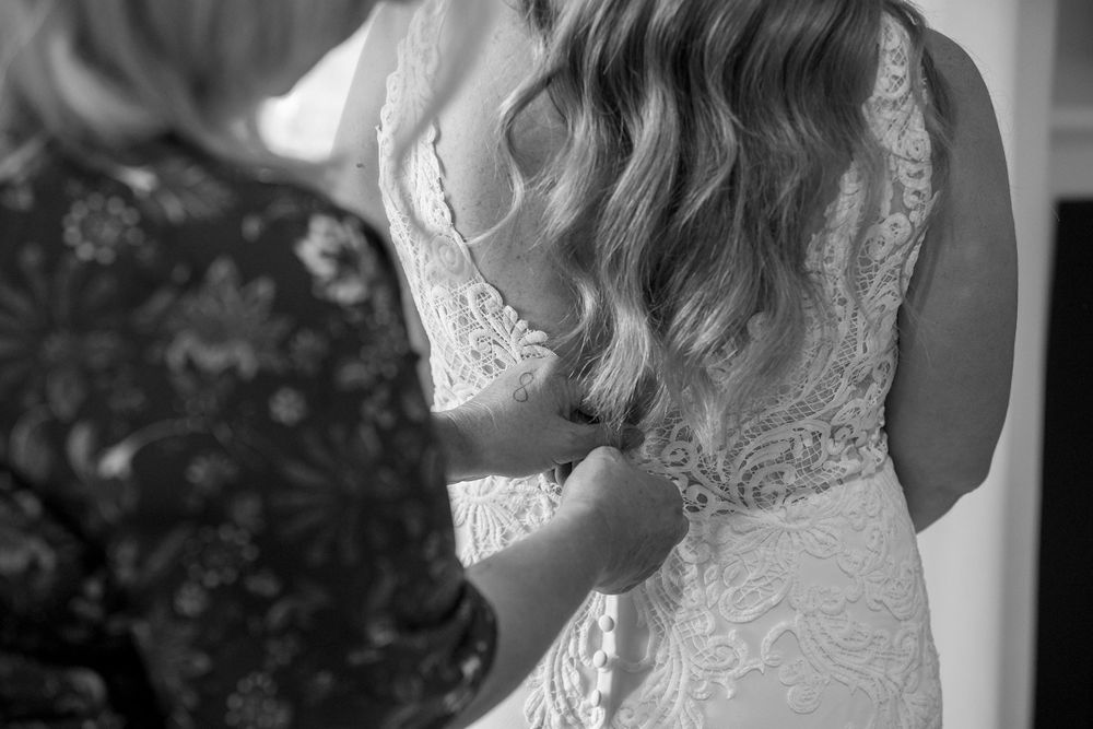 Brides mum helping her daughter with her wedding dress before their ceremony at Lancemmore in Milawa