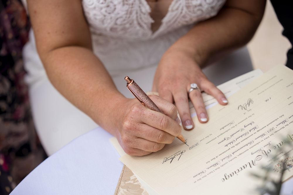 Bride signing the register during their ceremony at Lancemore Milawa captured by Jason from Jason Robins Photography