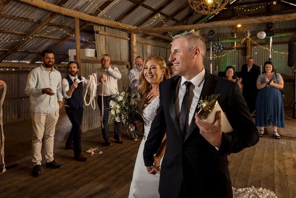 The Bride and Groom enter their wedding reception at the Milawa Providore captured by Jason Robins.