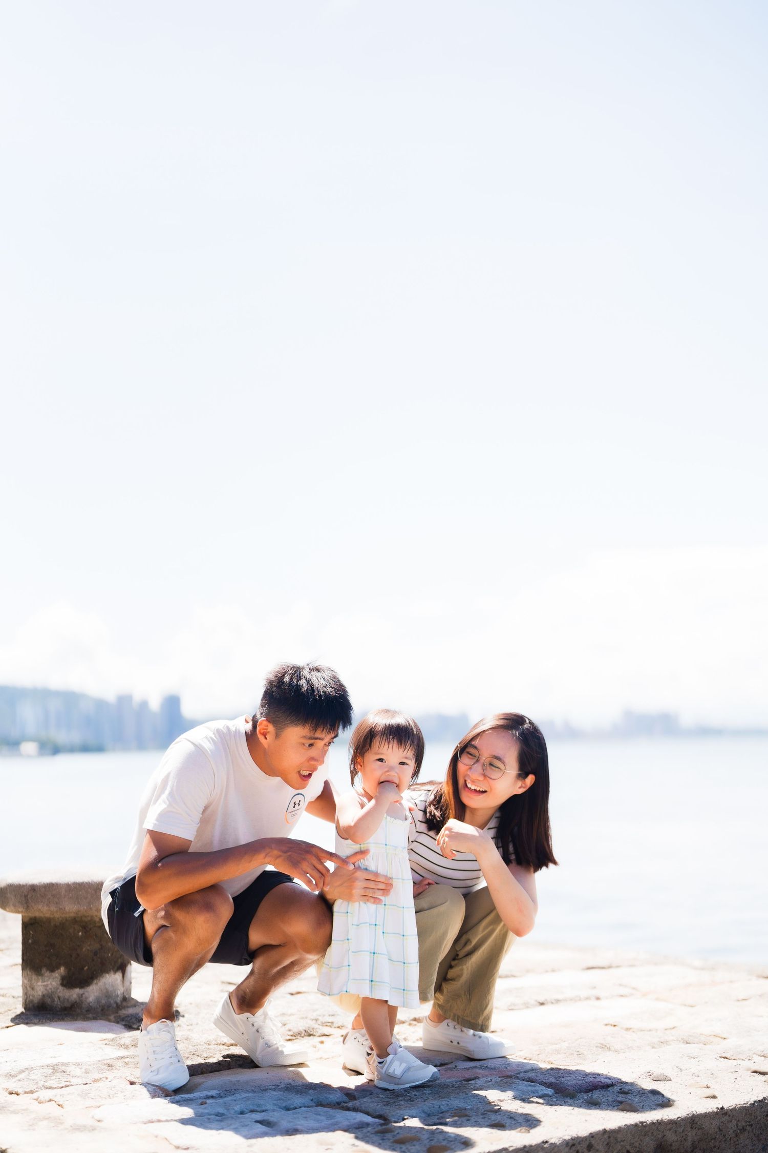 Family enjoying a sunny day together by the waterfront.