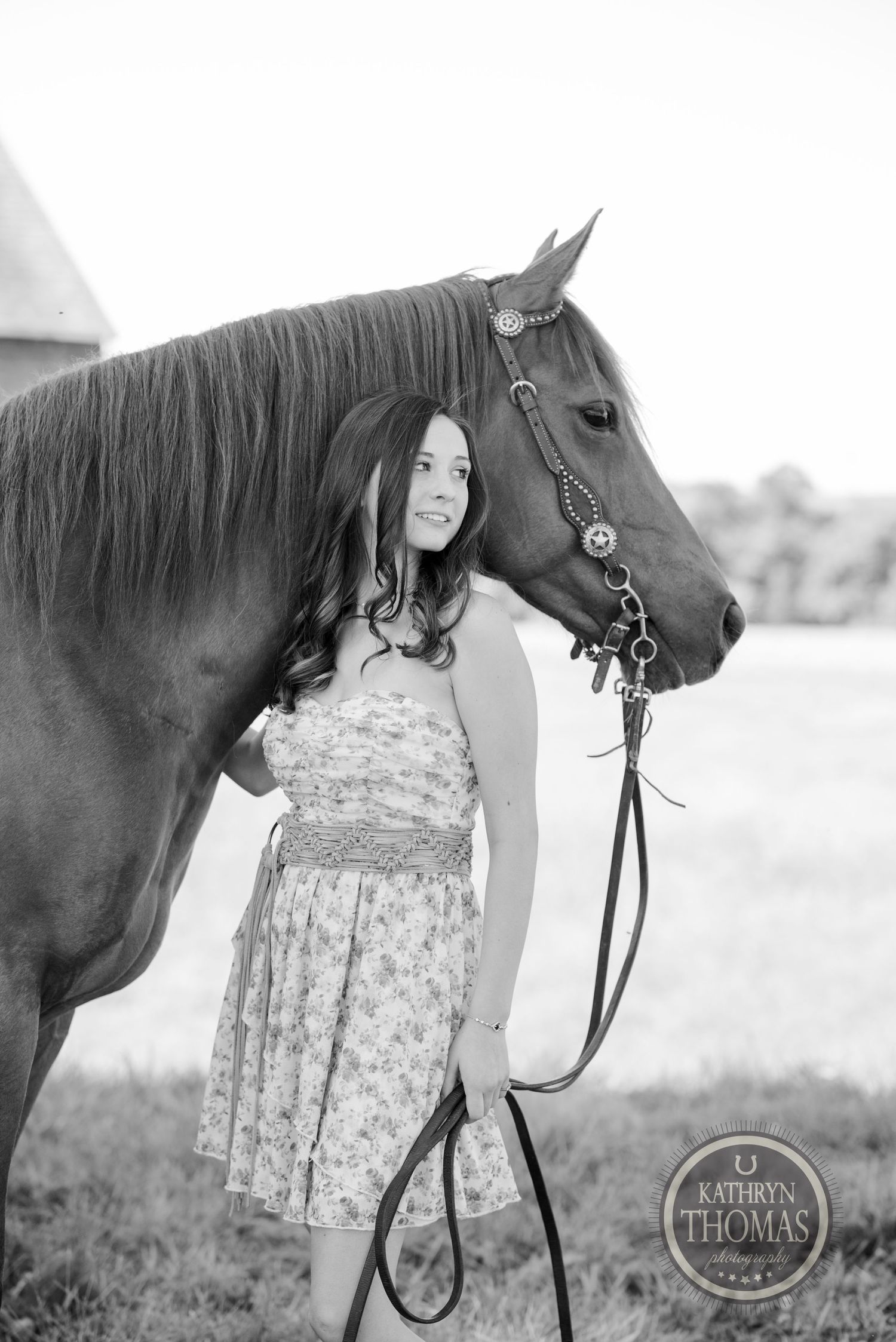 A dramatic black and white portrait featuring a horse and subject against a light background.