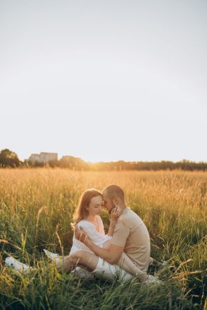 An intimate moment captured in a summer meadow during golden hour.