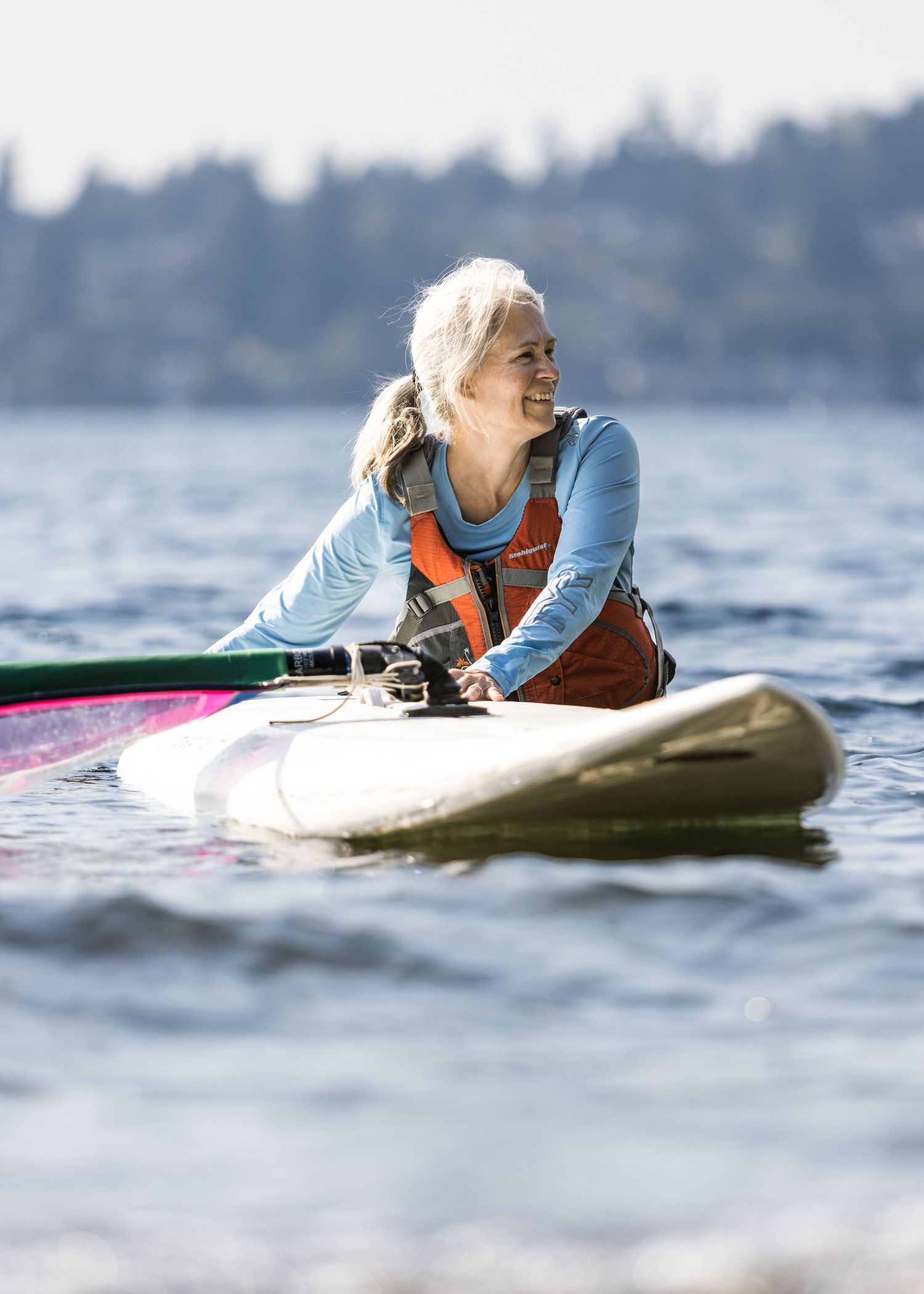 woman smiling after coming in from a session windsurfing on Lake Washington
