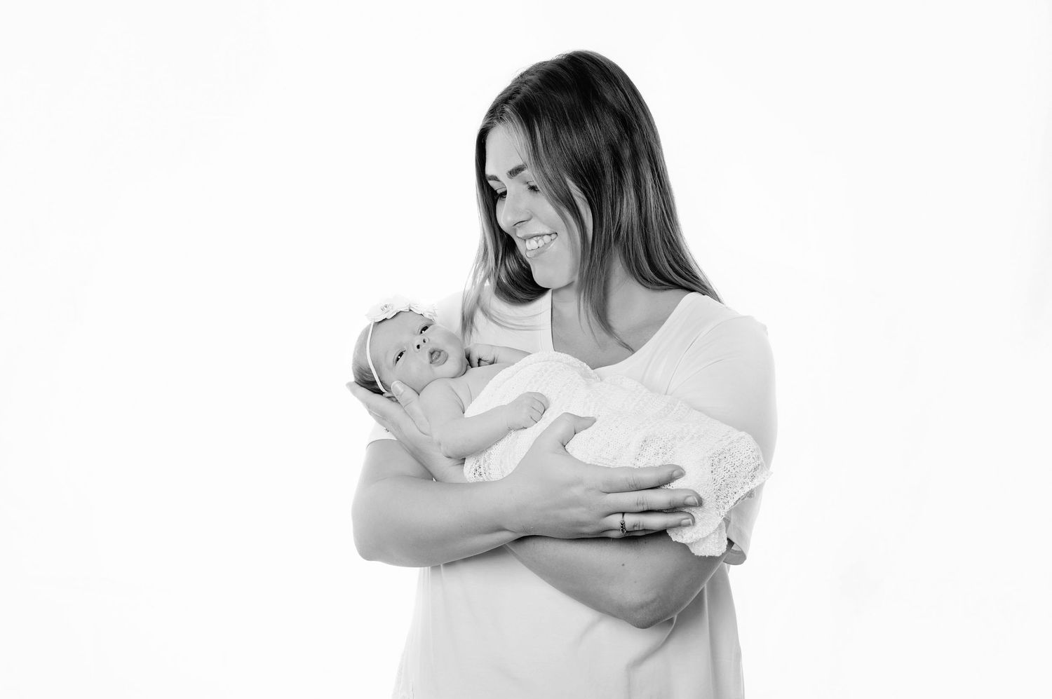 mother holding baby black and white