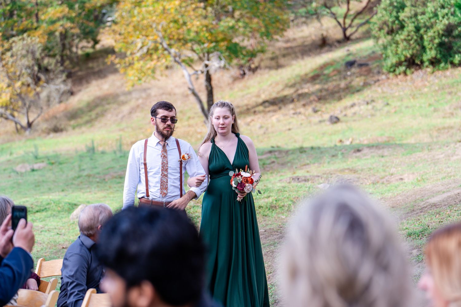 groomsman and bridesmaid in green