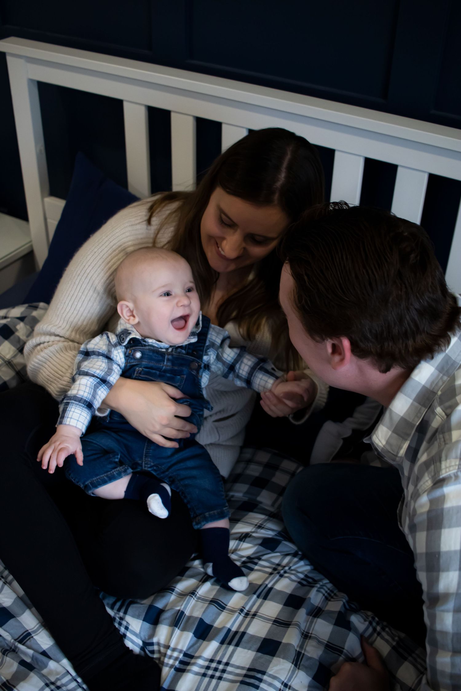 A family laughing on the bed