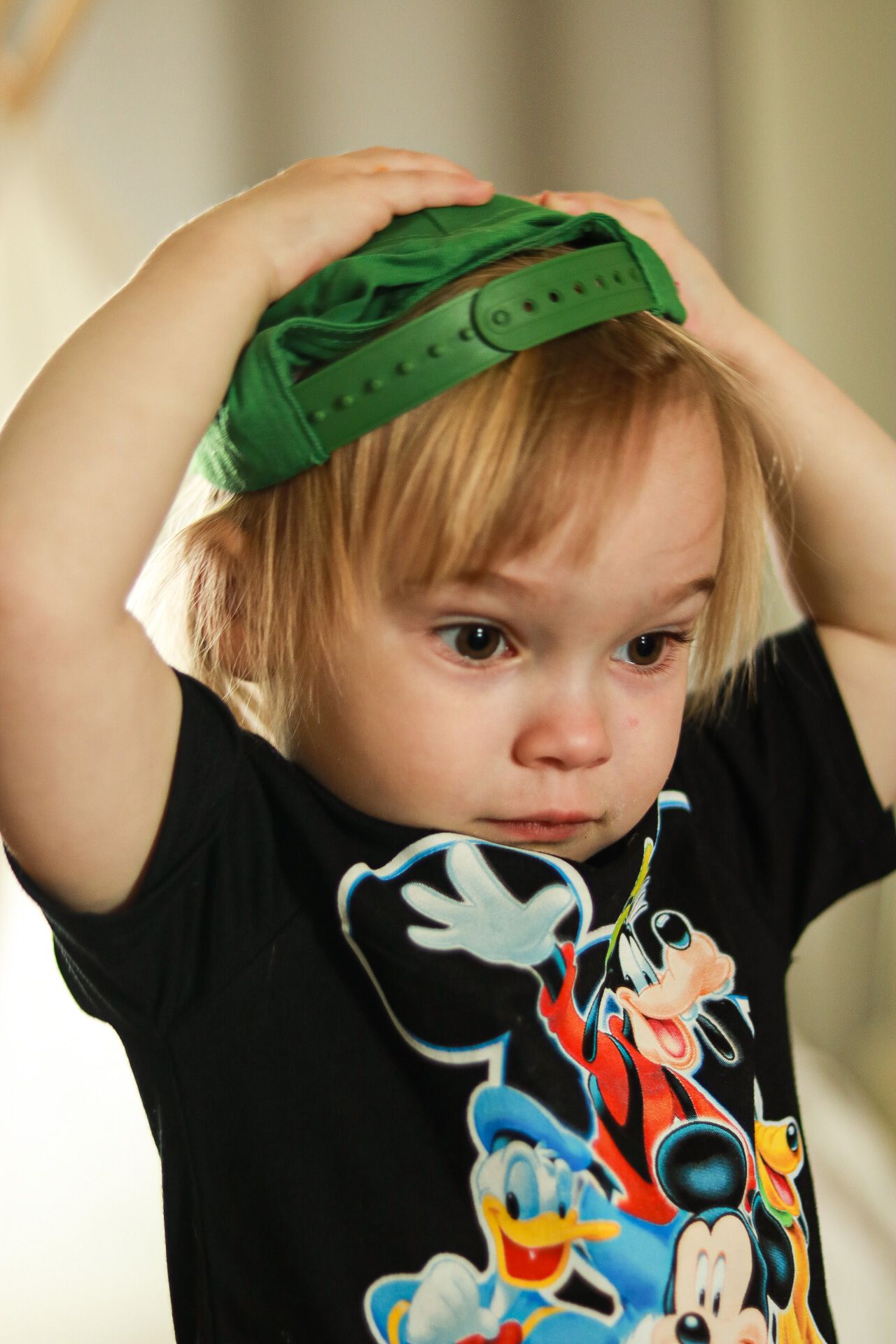 Photo of a toddler with her hat on backward