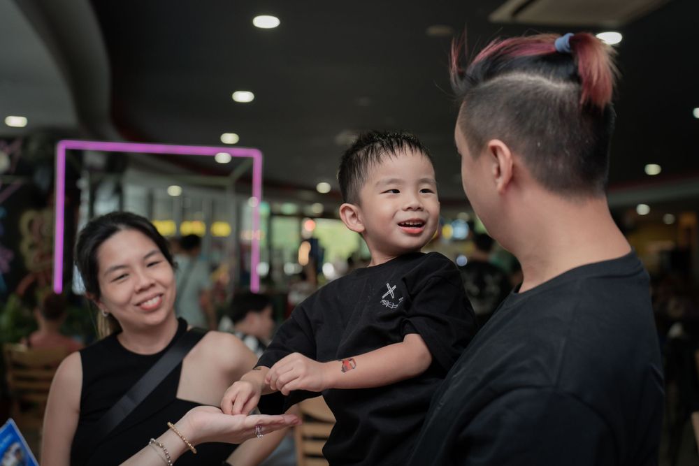 Joyful moment at an indoor celebration with bright lights and smiles.