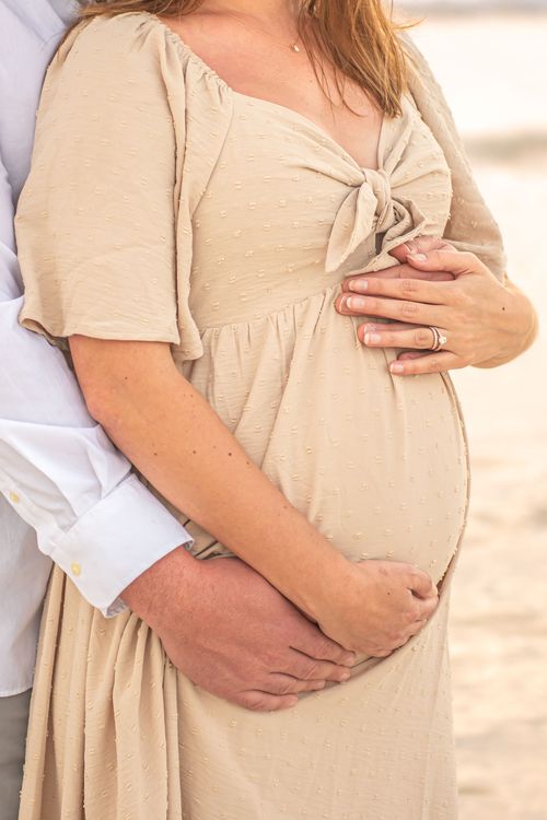 maternity photo of belly at beach sunset for a photography portfolio