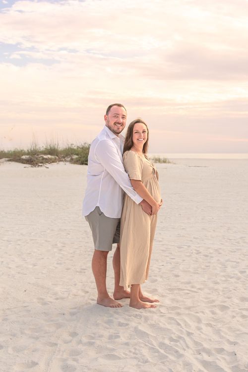 maternity photo of couple at beach sunset for a photography portfolio