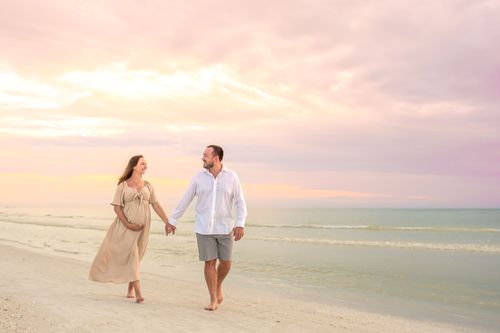 maternity photo of couple at beach sunset